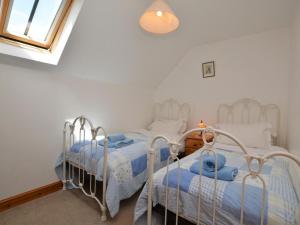 two beds in a bedroom with white walls and a window at 4 Bed in Sherborne oc-folow in Long Burton +22 photos