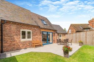 a brick house with a patio and a fence at 2 Bed in Melbourne oc-t29849 in Kingʼs Newton
