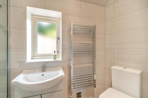 a bathroom with a sink and a toilet and a window at 2 Bed in Melbourne oc-t29849 in Kingʼs Newton