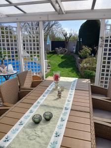 a table with a glass of wine on a patio at Ferienzimmer Bella Casa in Biebesheim