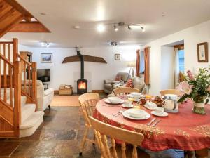 a living room with a table and a fireplace at 3 Bed in Sherborne oc-folwr in Long Burton