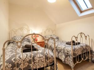 two beds in a bedroom with a window at 3 Bed in Sherborne oc-folwr in Long Burton +12 photos