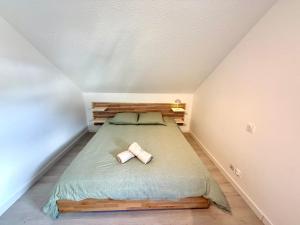 a small bedroom with a bed in a attic at Appartement calme parking in Le Monastère +2 photos