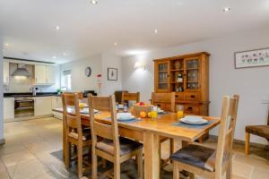 a kitchen and dining room with a wooden table and chairs at 3 Bed in Crakehall oc-m30356 in Crakehall
