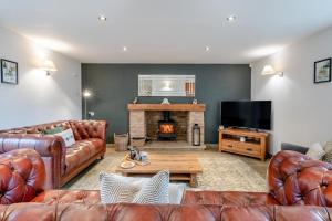 a living room with leather furniture and a fireplace at 3 Bed in Crakehall oc-m30356 in Crakehall