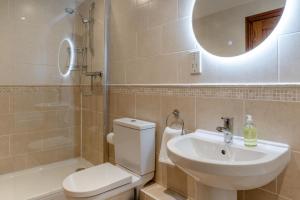 a bathroom with a toilet and a sink and a mirror at 3 Bed in Crakehall oc-m30356 in Crakehall +26 photos