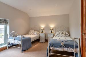 a bedroom with two beds and a window at 3 Bed in Crakehall oc-m30356 in Crakehall