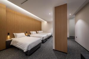 a hotel room with two beds and a wall at Nesto Hongdae in Seoul +140 photos