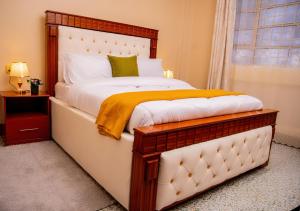 a bedroom with a large bed and a window at Chuma's home in Arusha
