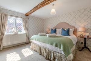 a bedroom with a large bed with blue pillows at 2 Bed in Beaulieu oc-b32274 in Exbury