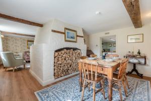 a living room with a table and a fireplace at 2 Bed in Beaulieu oc-b32274 in Exbury