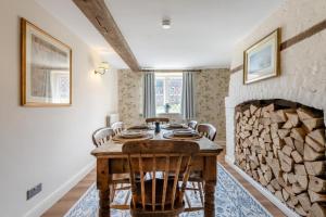 a dining room with a table and a fireplace at 2 Bed in Beaulieu oc-b32274 in Exbury +38 photos