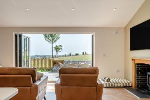 a living room with a fireplace and a tv at 3 Bed in Adgestone oc-a32613 in Brading
