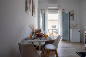 a small dining room with a table and chairs at Mia's Studio in Corfu