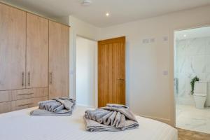 a bedroom with a bed with towels on it at 3 Bed in Adgestone oc-a32613 in Brading