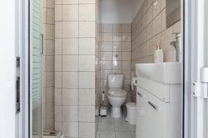 a small bathroom with a toilet and a sink at Mia's Studio in Corfu +16 photos