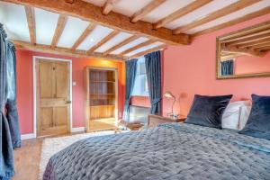 a bedroom with a large bed and orange walls at 1 Bed in Crayke oc-g33754 in Crayke