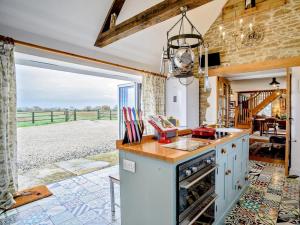 an open kitchen with a view of a field at 2 Bed in Lechlade oc-77493 in Langford