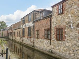 an old brick building next to a canal at Amber House in Dorchester