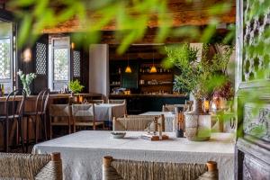 a table in a restaurant with tables and chairs at Maison lyly 300 Year Historical Cultural Courtyard and Ancient City View in Lijiang +58 photos