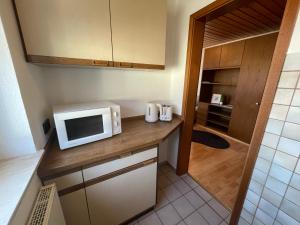 a small kitchen with a microwave on a counter at Appartement an der Steinach in Nagold