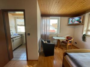 a room with a bed and a kitchen with a table at Appartement an der Steinach in Nagold