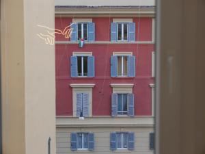 a building with blue and white windows on it at Equi60 in Rome