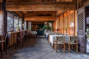 a restaurant with wooden walls and tables and chairs at Maison lyly 300 Year Historical Cultural Courtyard and Ancient City View in Lijiang