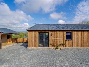 a wooden cabin with a black roof at 2 Bed in Lancaster oc-53510 in Beetham +13 photos