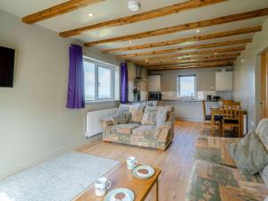a living room with a couch and a table at 2 Bed in Lancaster oc-53510 in Beetham