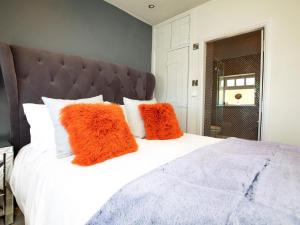a bedroom with a white bed with orange pillows at 1 Bed in Richmond oc-82829 in Gilling +8 photos