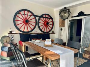 a dining room with two large wheels on the wall at Exclusivité - La Maison à Vapeur avec climatisation in Nantes +8 photos