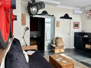 a living room with a couch and a table at Exclusivité - La Maison à Vapeur avec climatisation in Nantes
