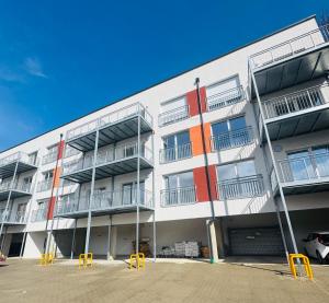 an apartment building with yellow chairs in front of it at Siegen Apartments - Modern & mit Parkplatz in Siegen
