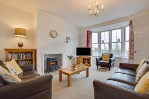 a living room with two couches and a fireplace at 4 Bed in Leyburn oc-ds370 in Leyburn