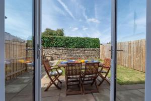 a patio with a table and chairs in a yard at 4 Bed in Leyburn oc-ds370 in Leyburn