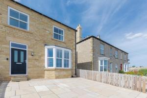 a brick house with a fence in front of it at 4 Bed in Leyburn oc-ds370 in Leyburn