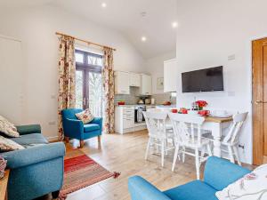 a kitchen and living room with a table and chairs at 2 Bed in Wellington oc-56950 in West Buckland