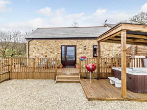 a cottage with a deck and a hot tub at 2 Bed in Wellington oc-56950 in West Buckland