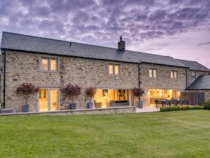 a large stone house with a lawn in front of it at 6 Bed in Richmond oc-80466 in Gilling