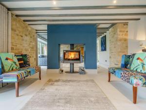 a living room with two chairs and a fireplace at 6 Bed in Richmond oc-80466 in Gilling