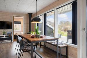 a dining room with a table and a large window at LF127-Vestervig-Gunhildsvej-27 in Vestervig