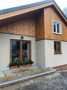 a house with a window and plants in front of it at Apartmany U vleku 6 in Ceske Petrovice
