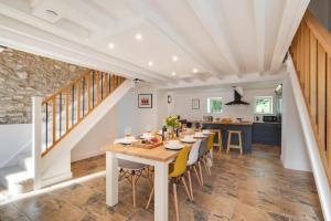 a dining room and kitchen with a table and chairs at 4 Bed in Buxton oc-dcoldd in Hartington