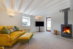a living room with a couch and a fireplace at 4 Bed in Buxton oc-dcoldd in Hartington