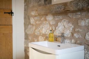 a bathroom with a sink and a stone wall at 4 Bed in Buxton oc-dcoldd in Hartington +35 photos