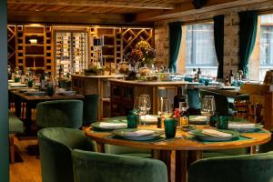 a restaurant with tables and chairs and wine racks at Hôtel de Verbier SUP in Verbier