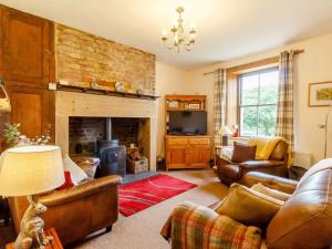 a living room with leather furniture and a fireplace at 2 Bed in Hexham oc-89086 in Bellingham