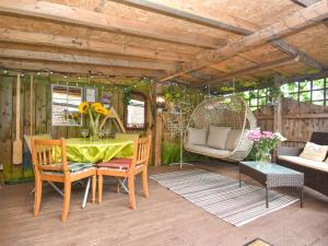 a patio with a table and chairs and a swing at 2 Bed in Hexham oc-89086 in Bellingham