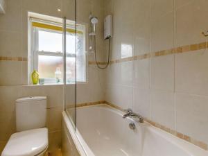 a bathroom with a tub and a toilet and a window at 2 Bed in Hexham oc-89086 in Bellingham +13 photos